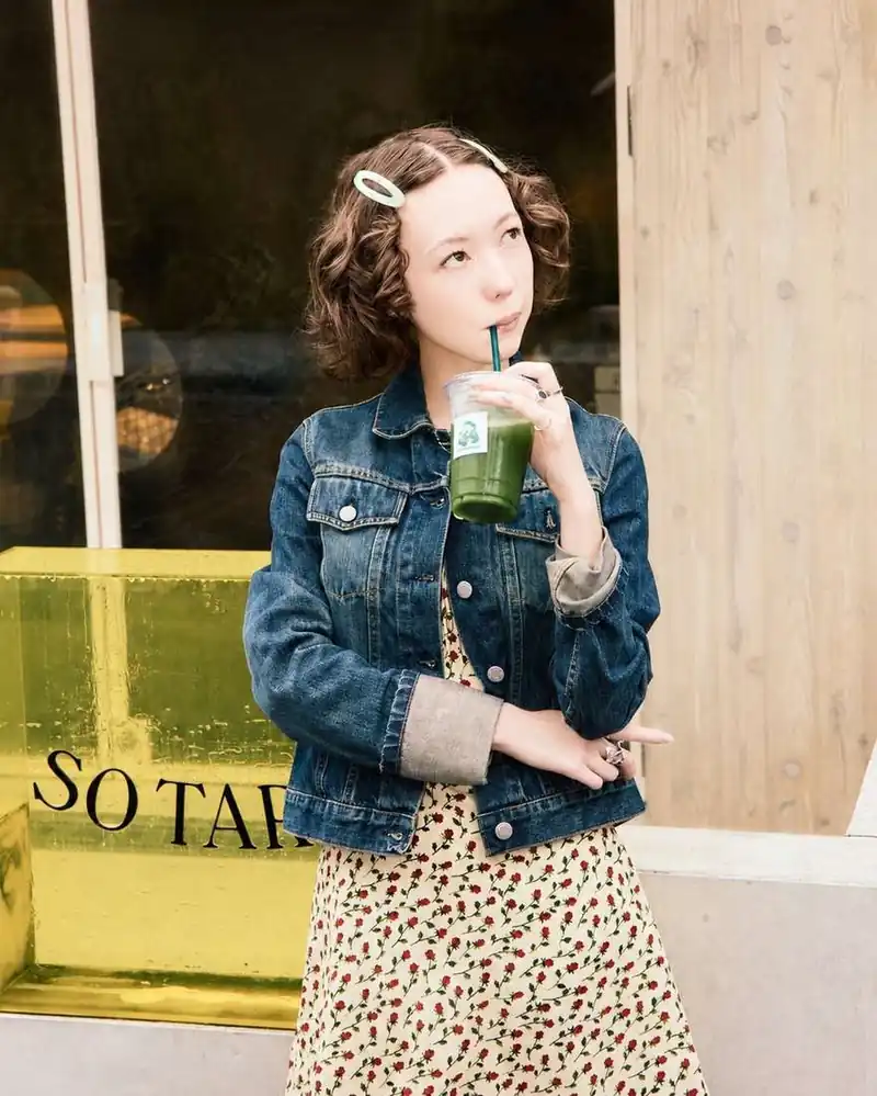A guest outside SO TARTE with an iced matcha